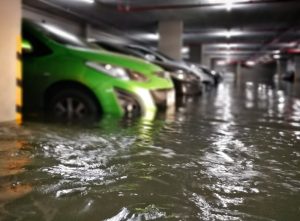 Car Insurance Banner - Cars parked in a flooded basement