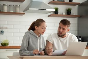 Small Loans Banner - Young couple assessing their financial situation before applying for a loan