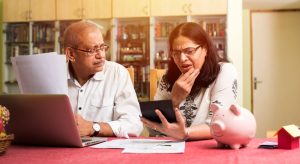 Small Loans Banner - Older couple worrying about money while reviewing their finances at the table